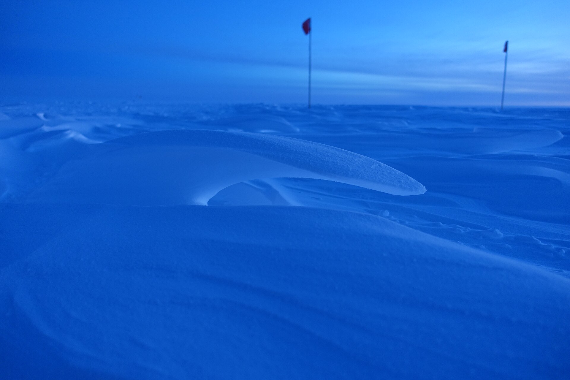 夜明けの青い光の中で風に削られた雪のうねり