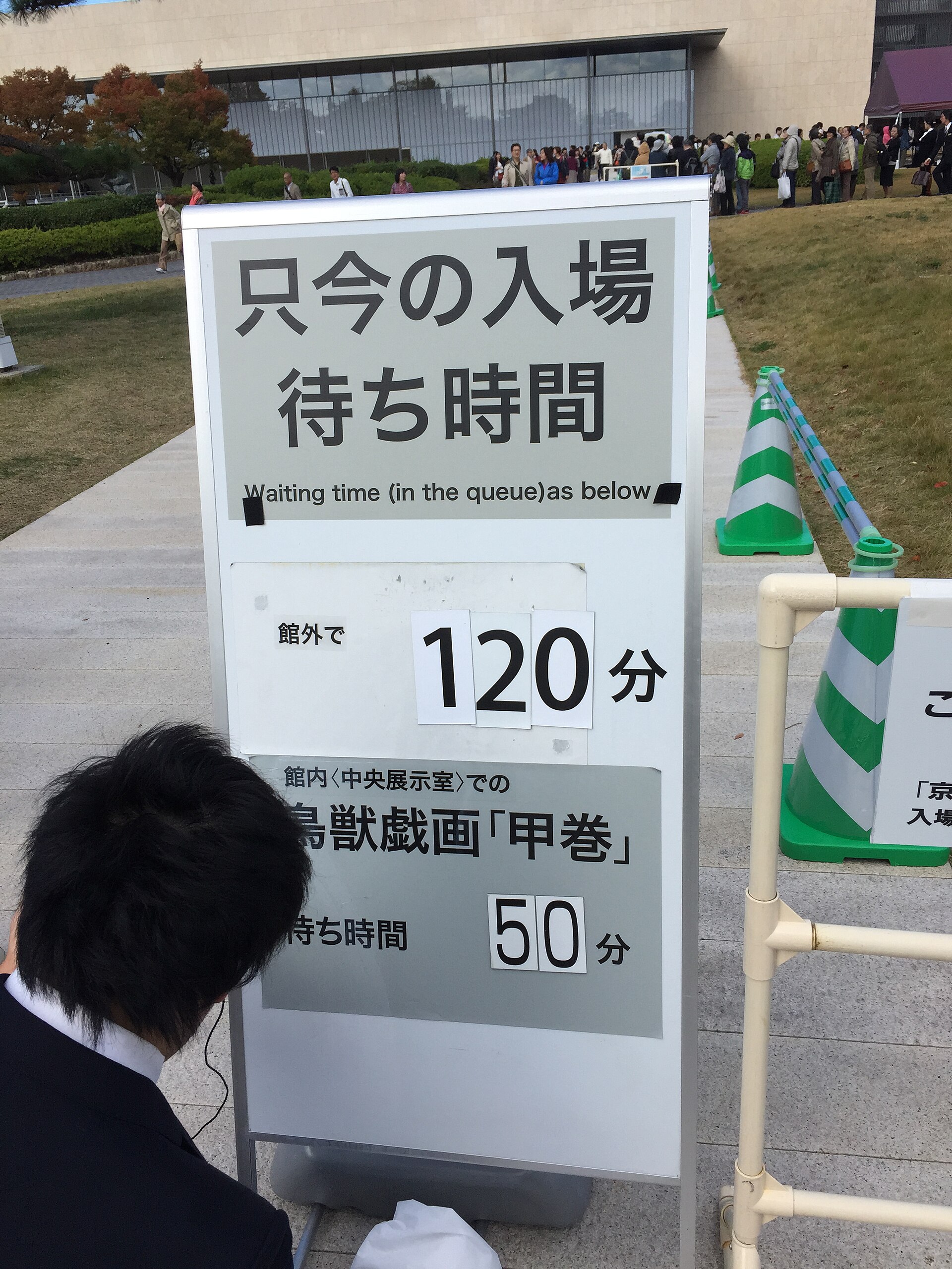 京都国立博物館に出ていた『只今の入場待ち時間』の掲示。館外120分、館内の鳥獣戯画『甲巻』は50分と書かれ、後ろに行列が伸びる